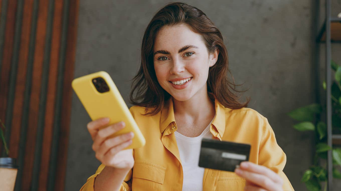 Things Broke People Waste Money On That The Wealthy Wouldn't Pay A Penny For broke woman happily spending money using her credit card and phone