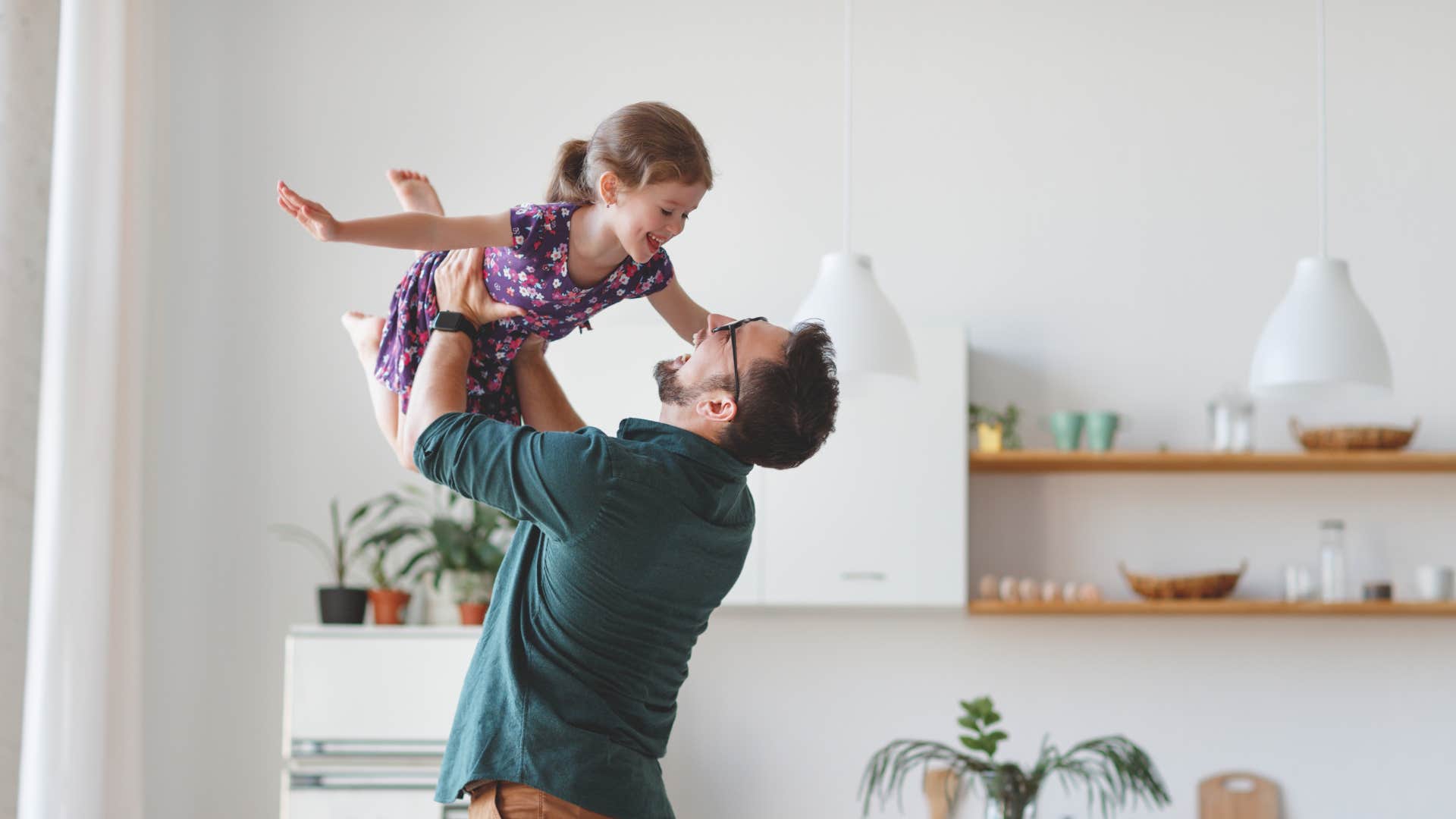 dad making daughter feel valued by swinging her around in the air