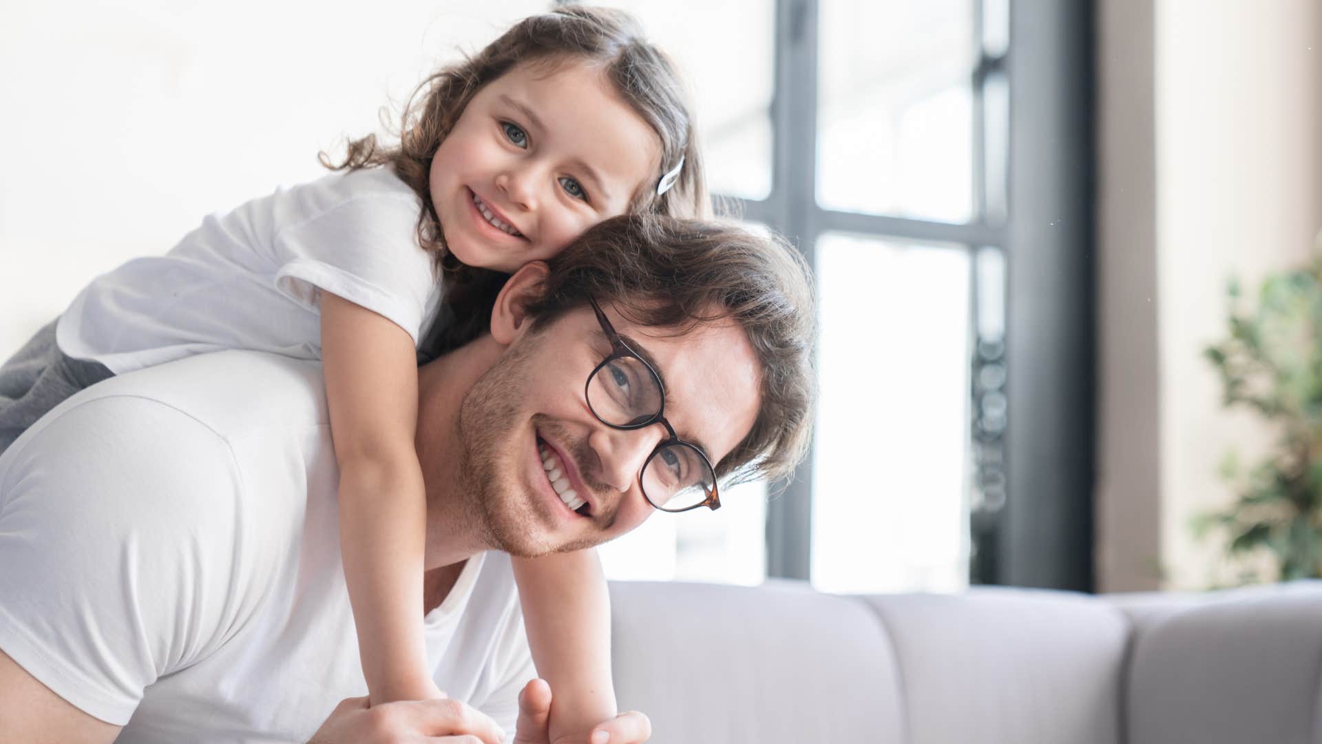 dad giving daughter a piggyback ride being a part of her life