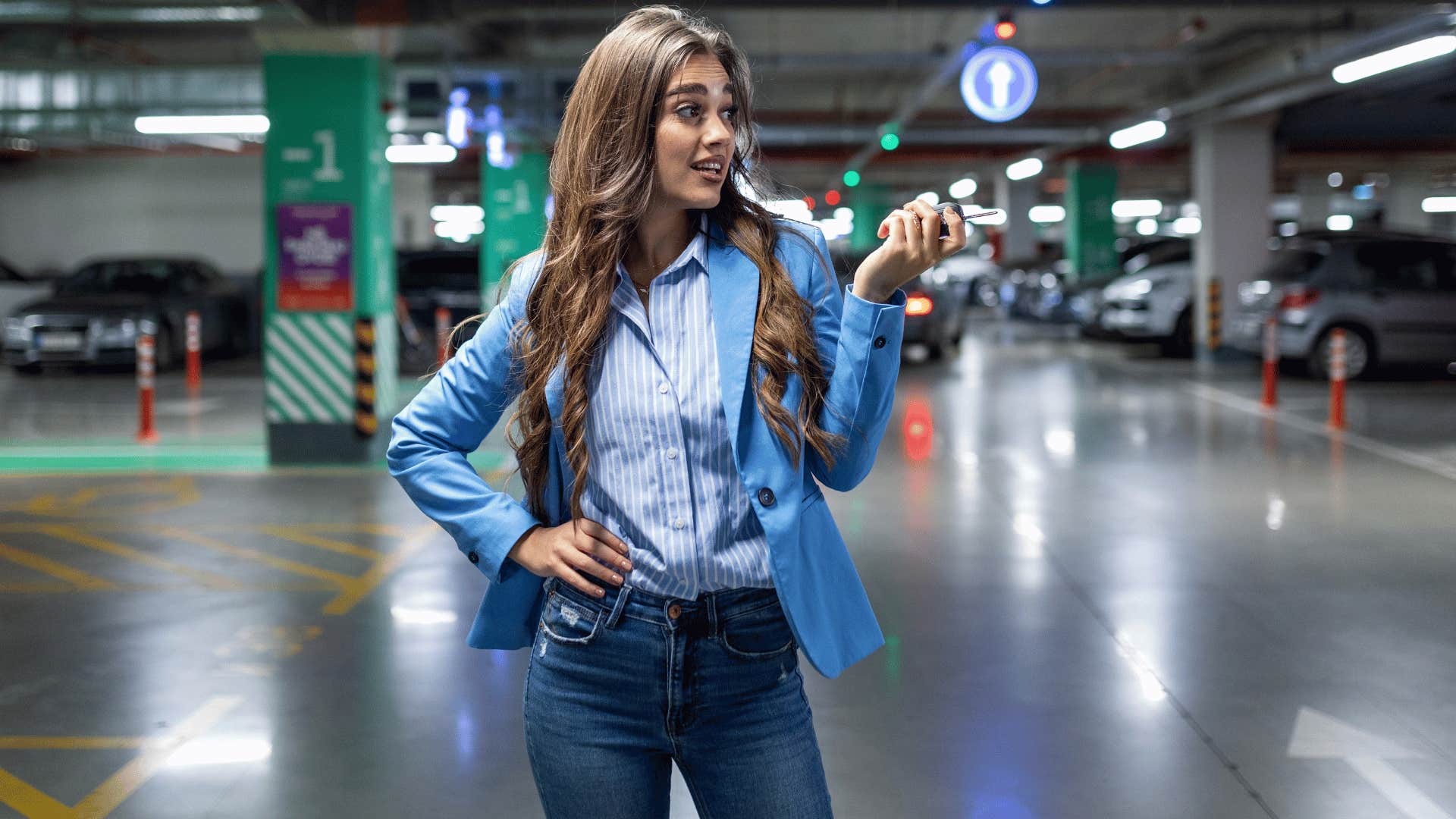 woman annoyed at lack of parking availability as she puts her hand on her hips and takes out her key