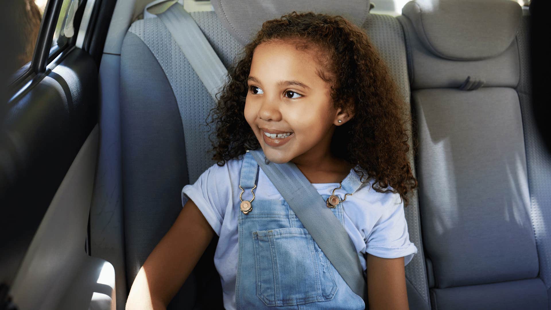 gen z kid using a seat belt