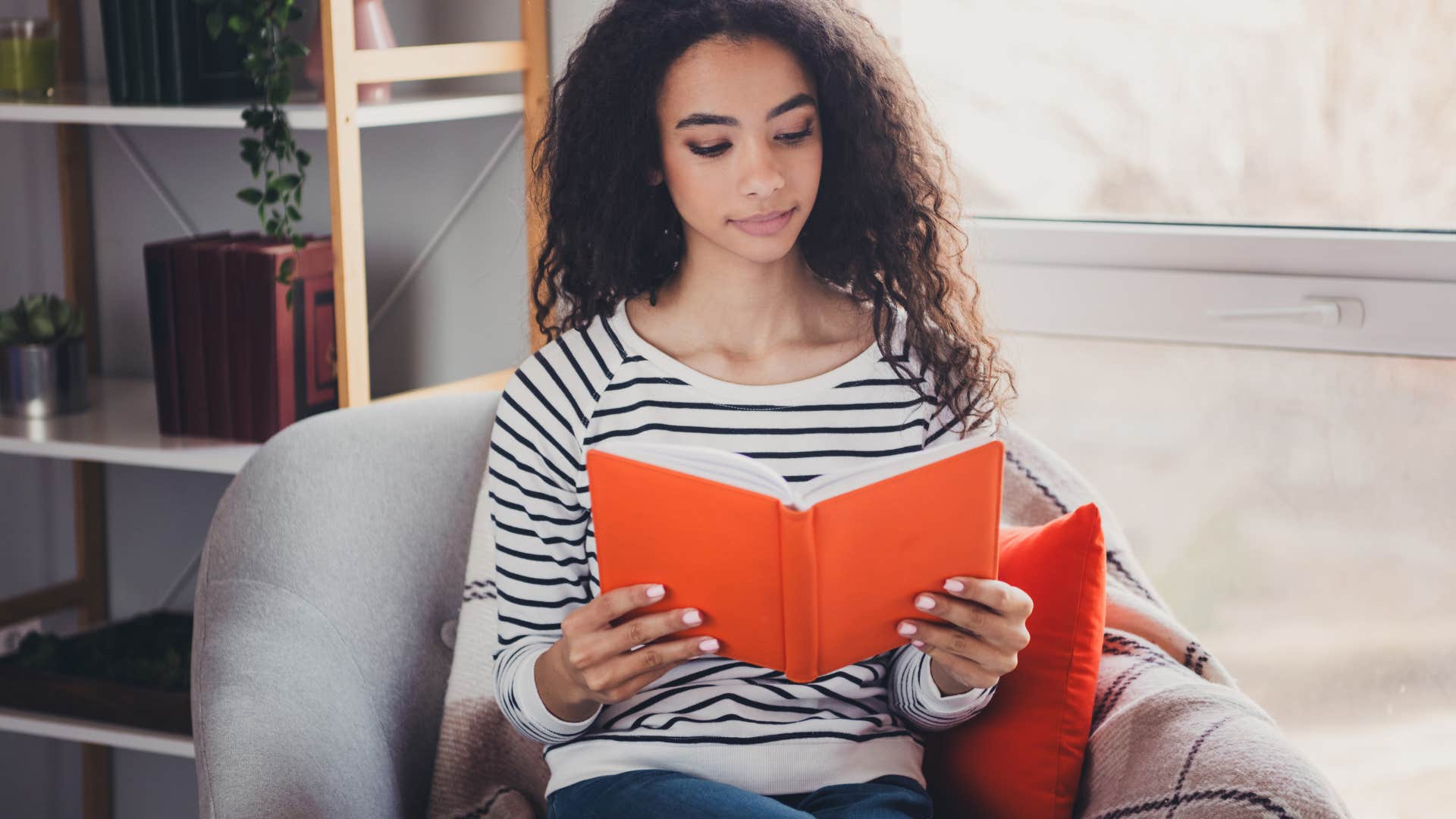 Gen Z woman reads a paper book instead of reading it through technology