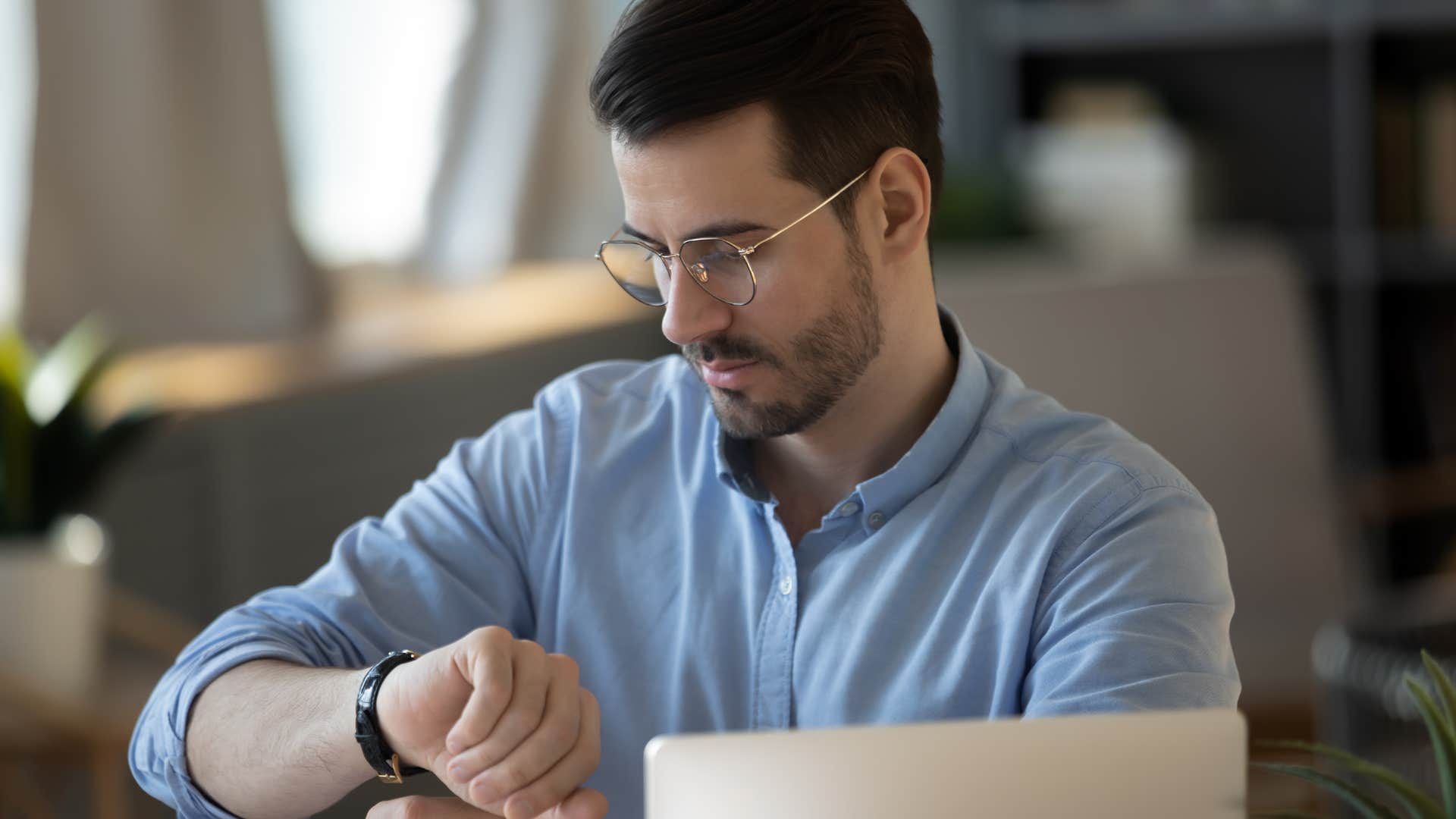 Gen Z worker checks the watch he’s wearing