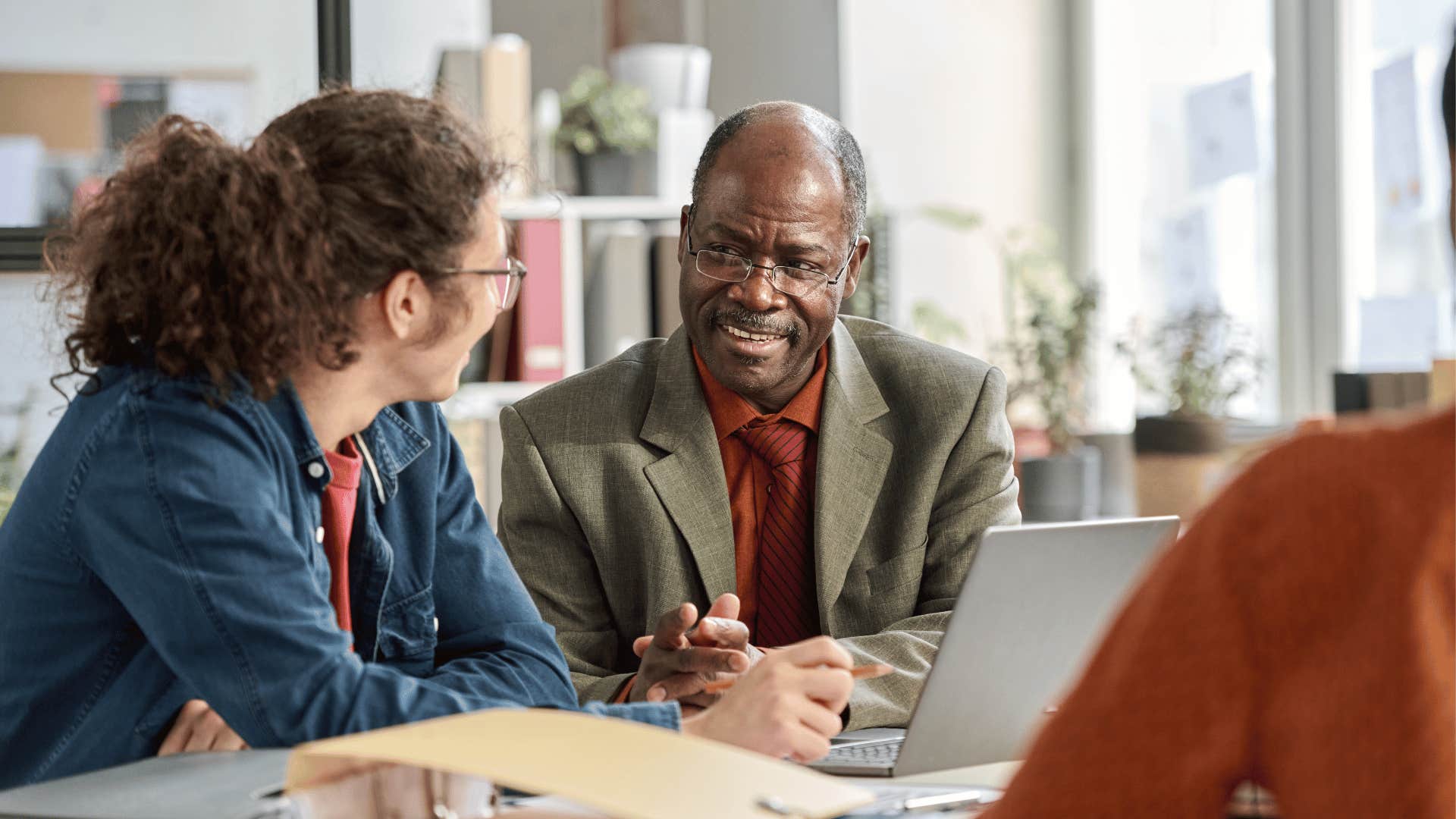A man from an older generation tells his young colleague that it’s a rite of passage to have a low starting pay.