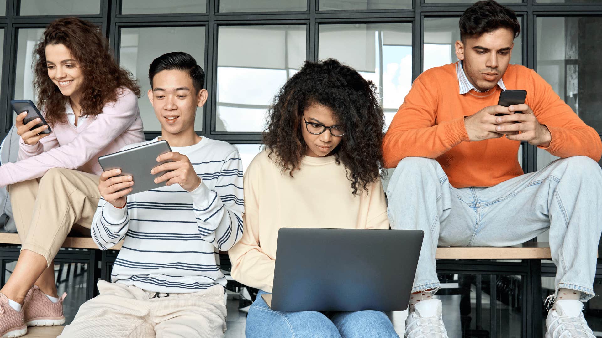 A group of gen z workers embrace newer technology at work.
