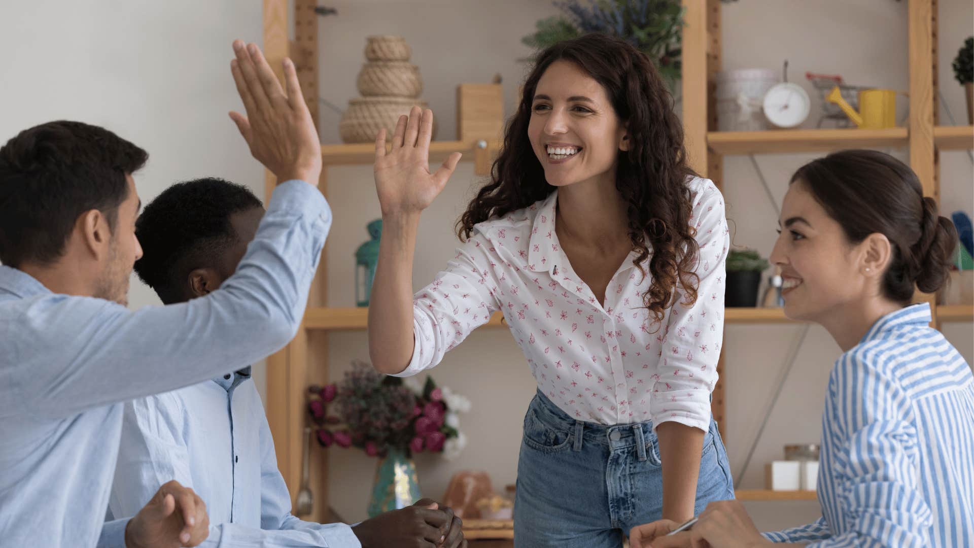 Woman hive fives group becasue she stopped over-apologizing