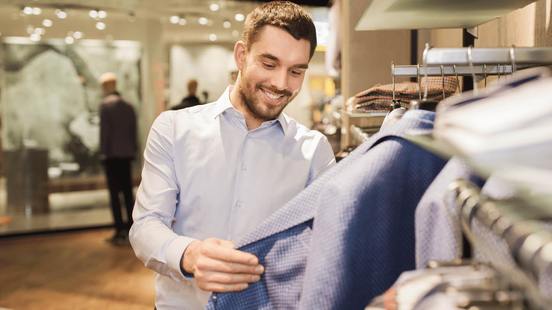 smiling man shopping for fast fashion and clothing
