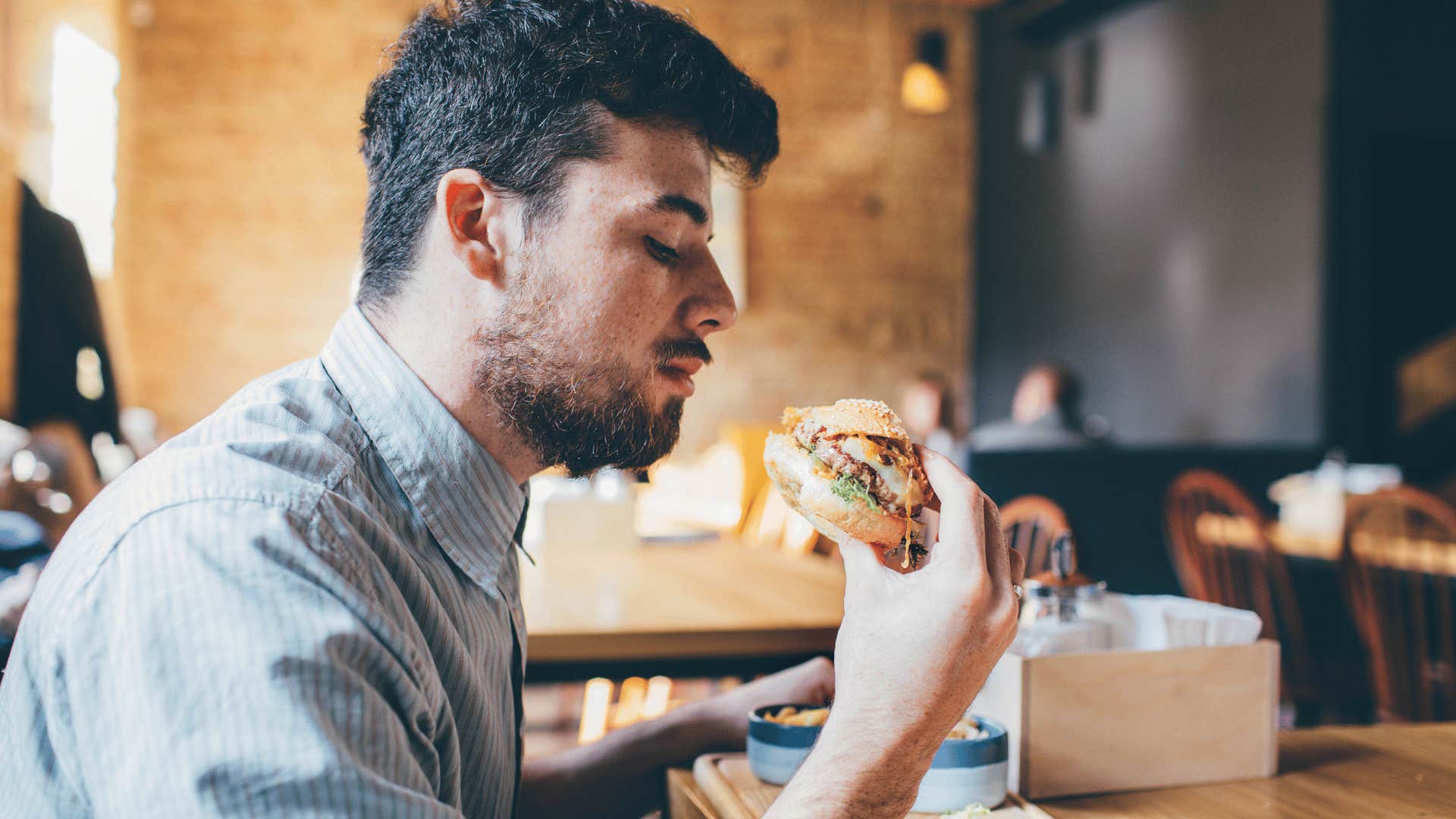 man about to eat fast food burger