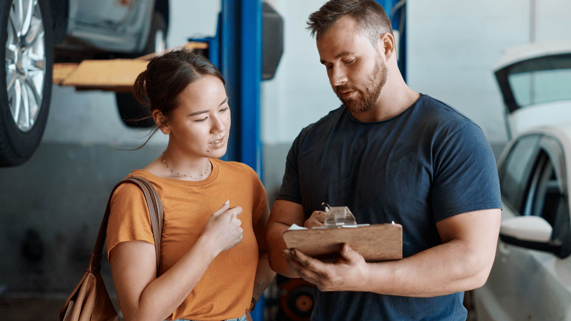 woman talking to mechanic about major car repairs