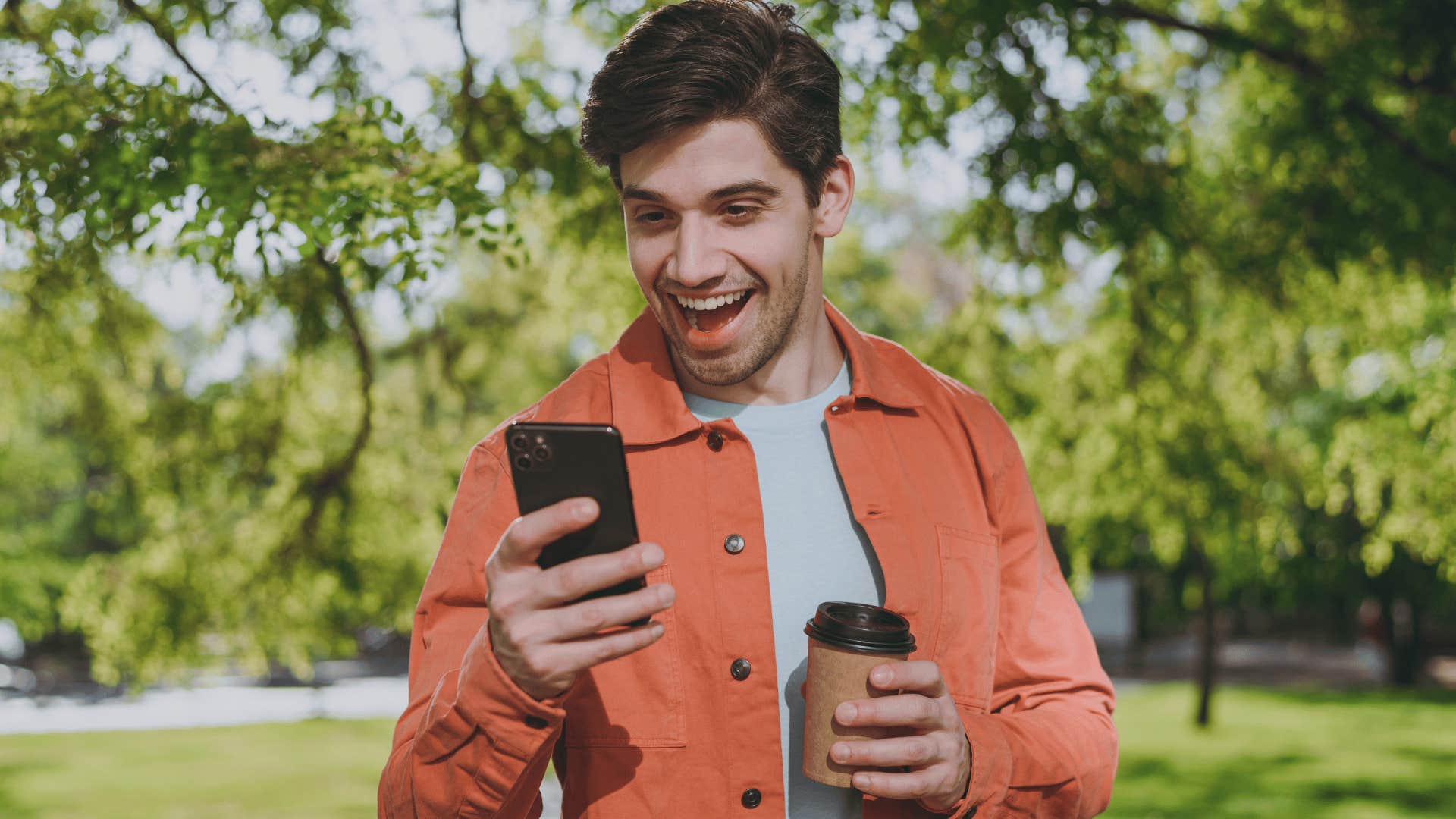 man smiling looking at the lottery tickets on his phone