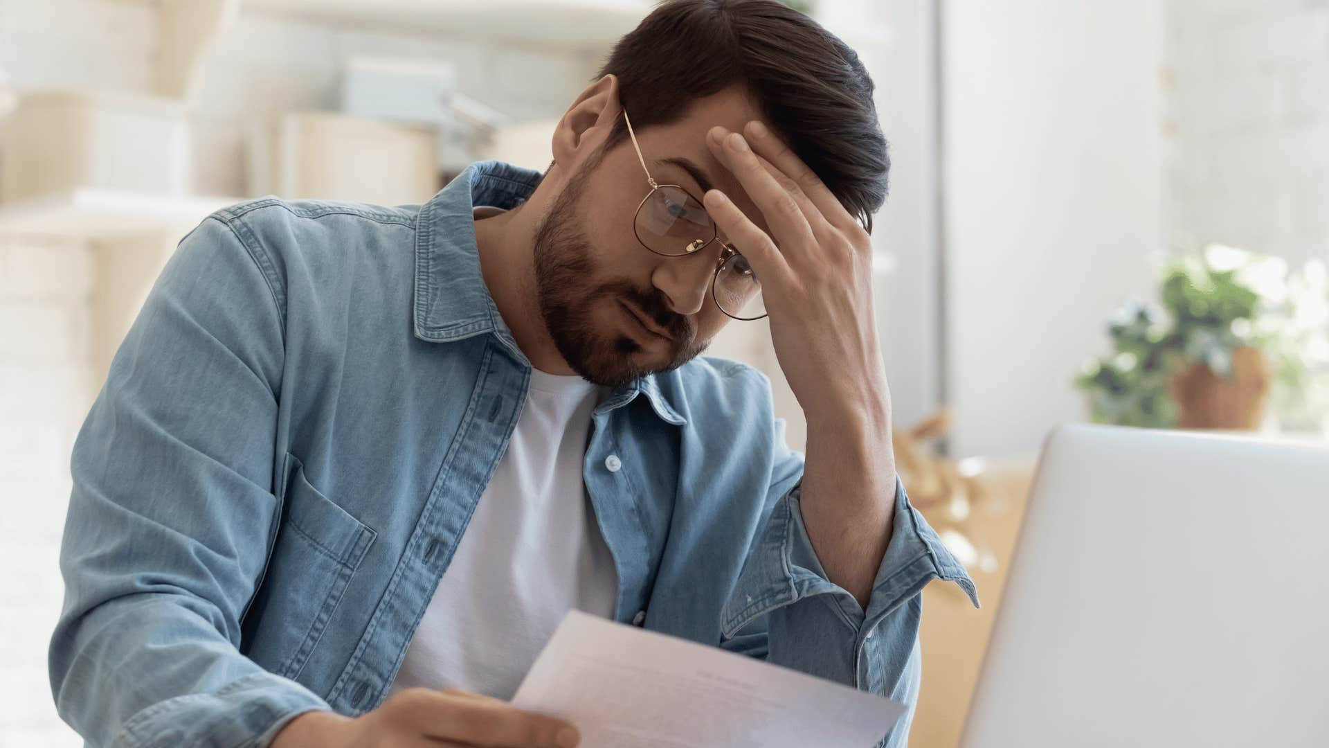 upset man looking at his rental bills