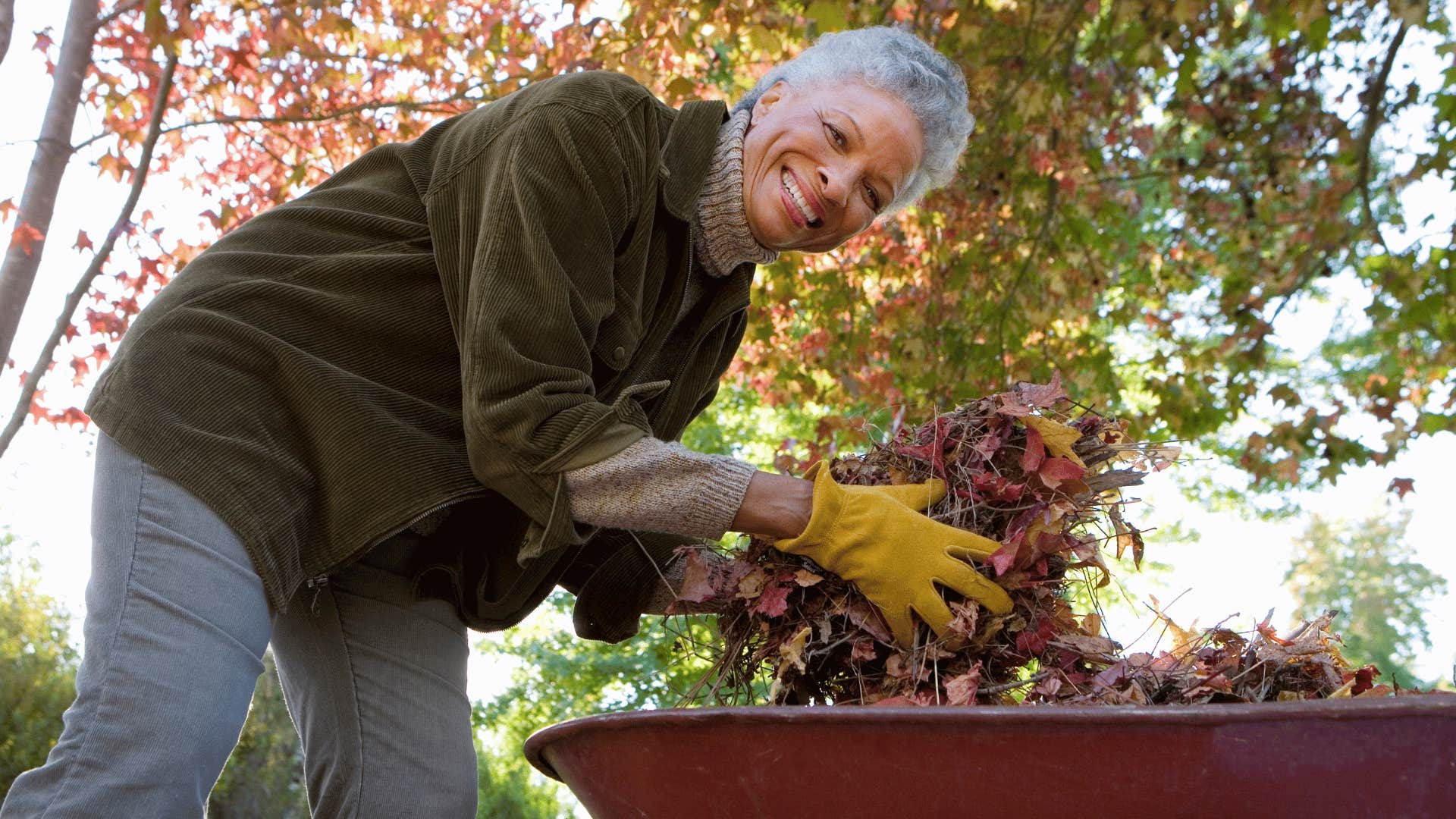 older woman using outdoor tools doing yard work