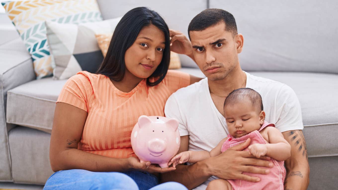 Things Middle-Class Families Waste Money On That Rich People Avoid financially stressed middle class family holding a piggy bank
