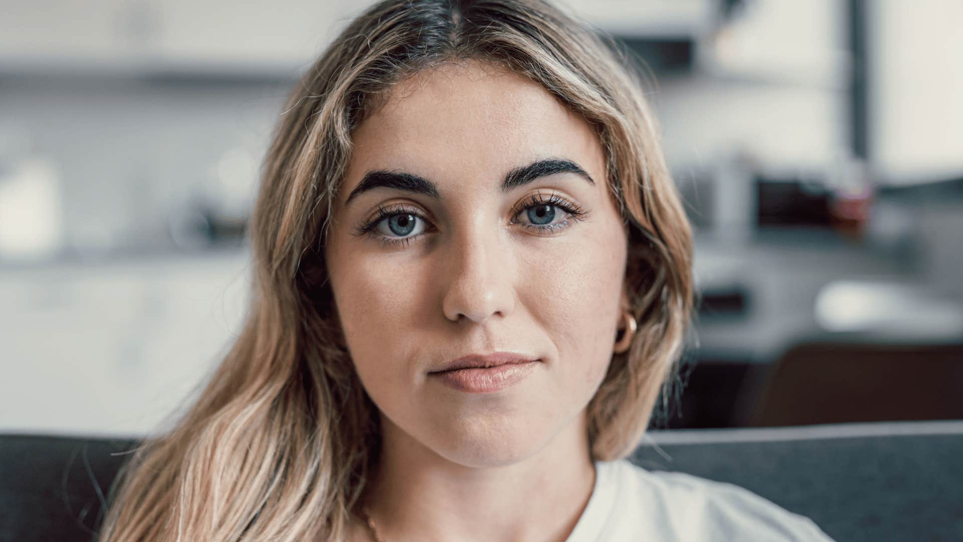 woman with full eyebrows looking serious