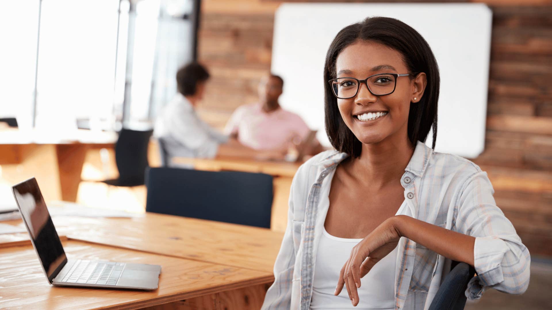 millennial woman smiling wearing glasses