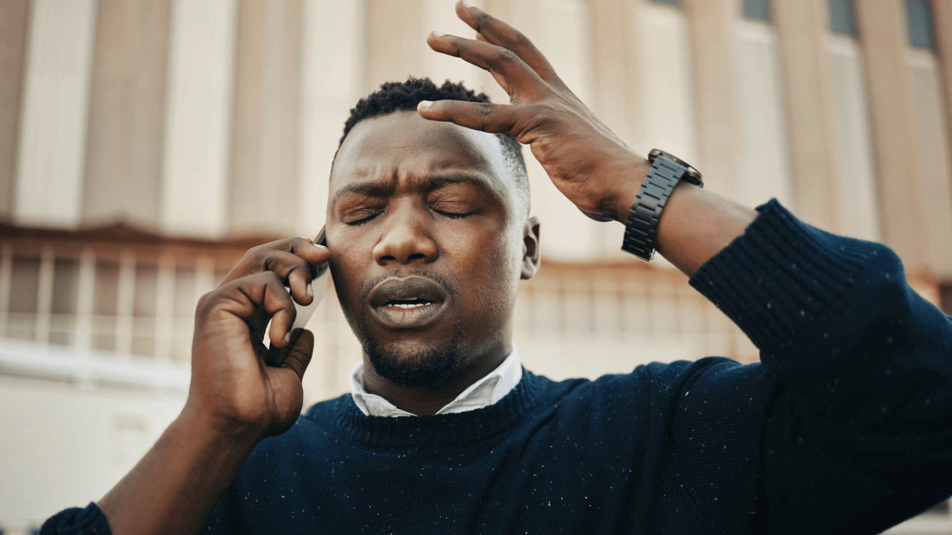 upset man on the phone expecting praise feeling disappointed