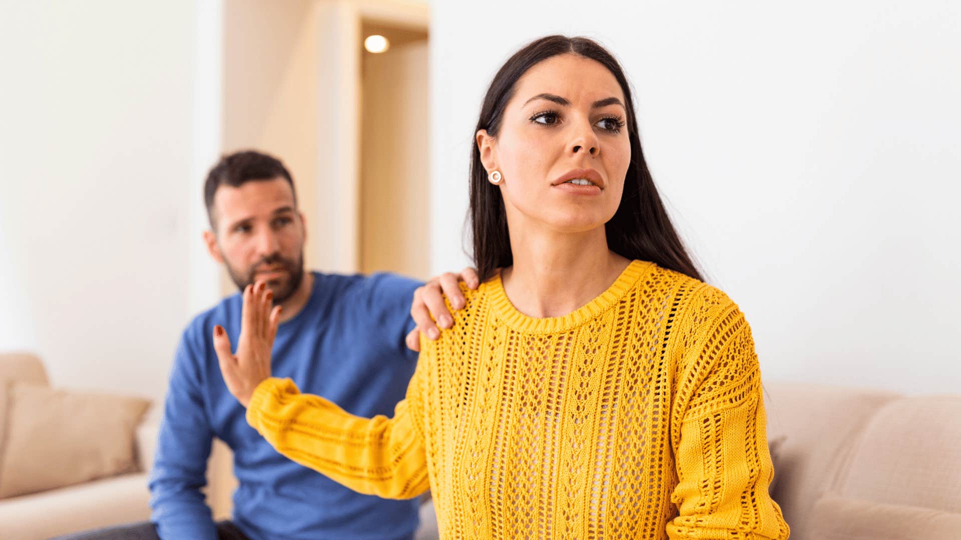upset millennial woman turned away from unloving partner