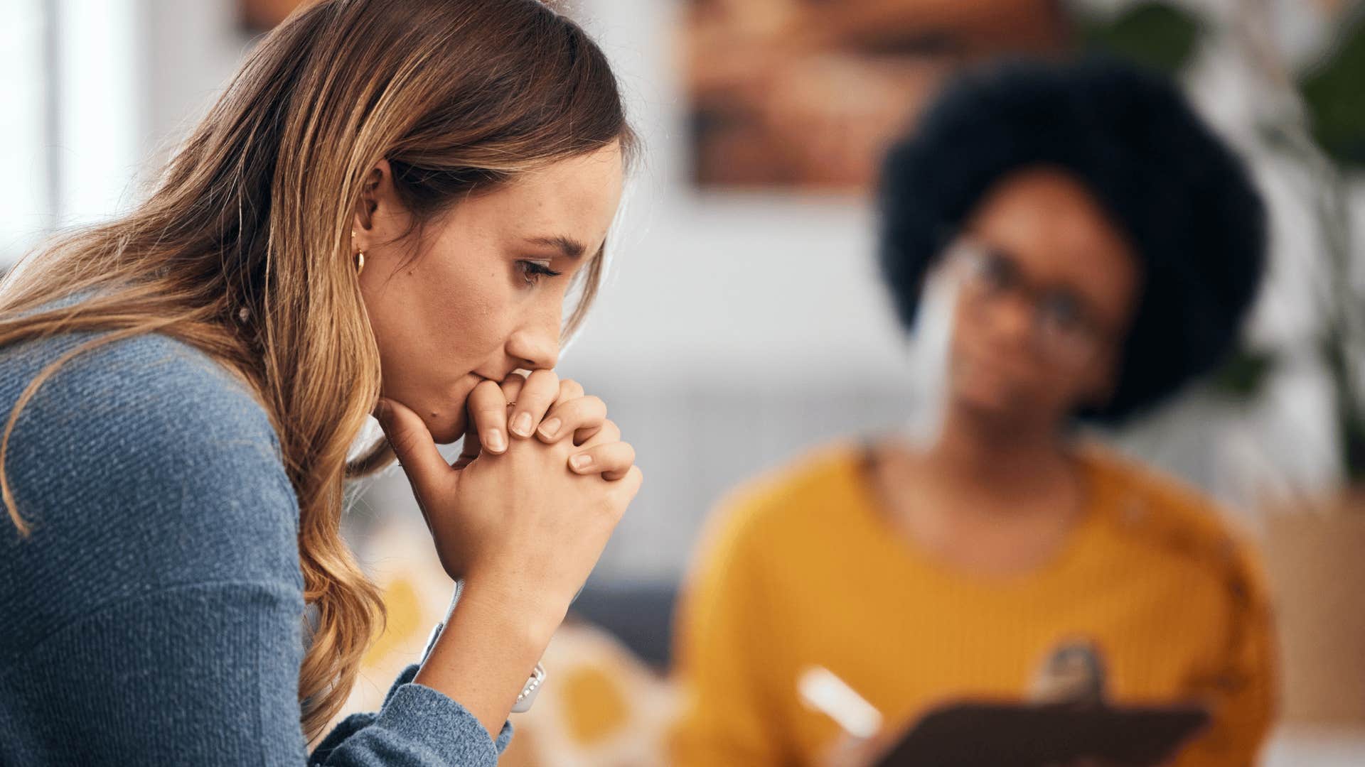 sad millennial woman with therapist talking to her
