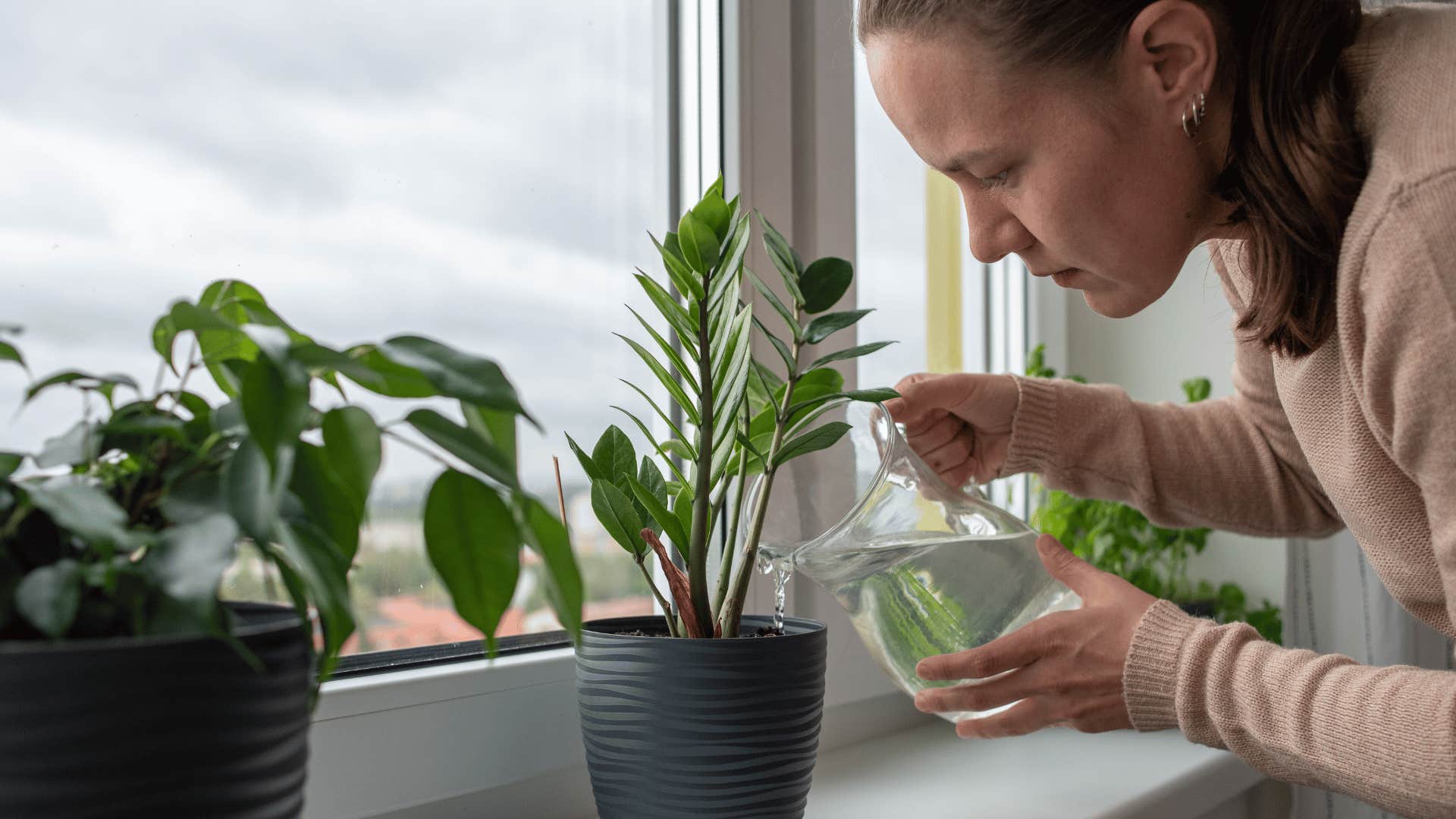 millennial woman tired from caring for her plants