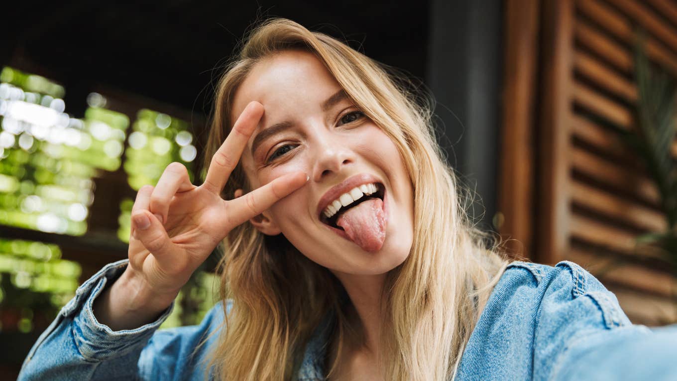 young gen z woman taking a silly selfie