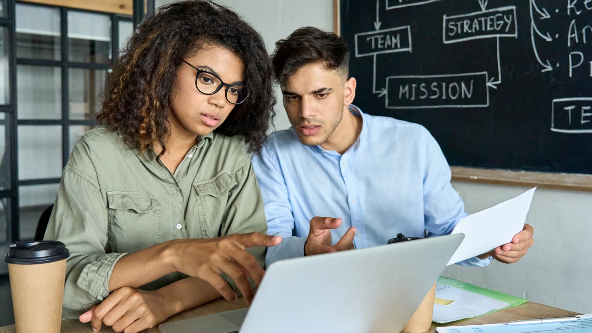 two young people who dont want to be leaders working from laptop