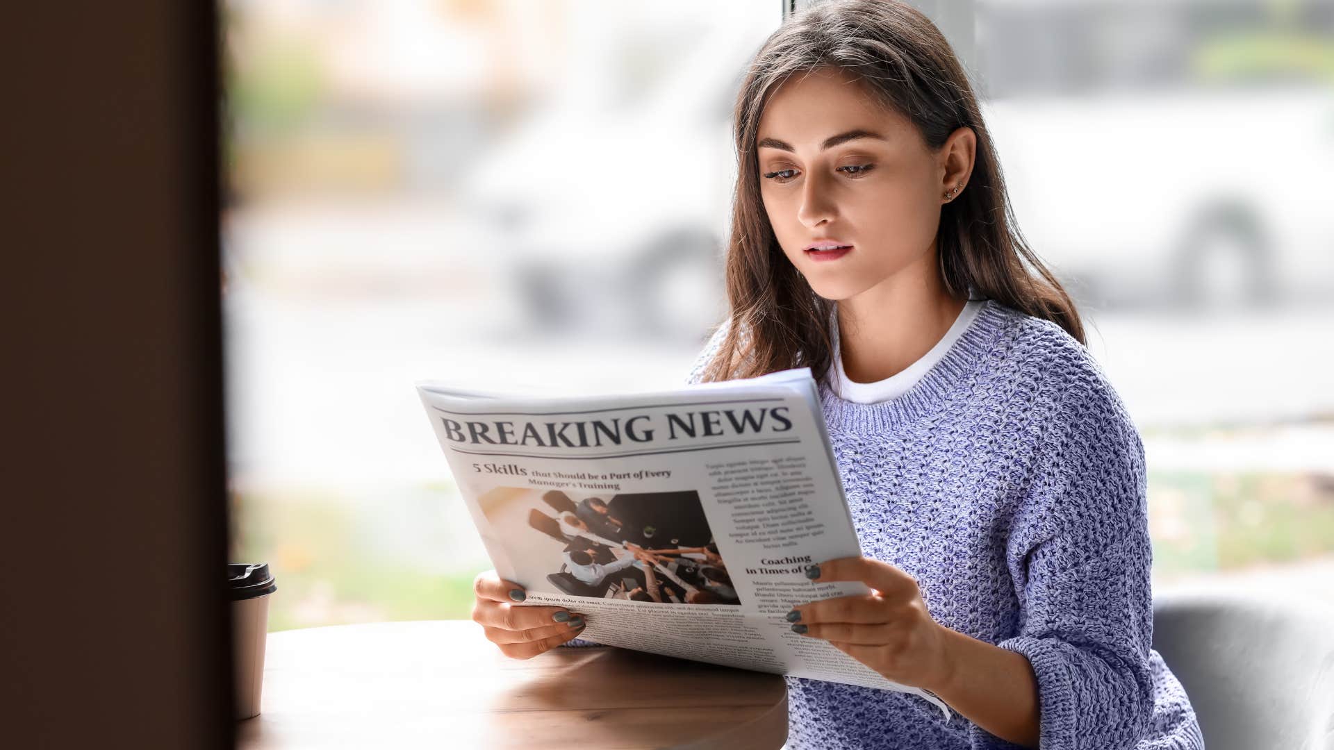 gen z woman reading a newspaper