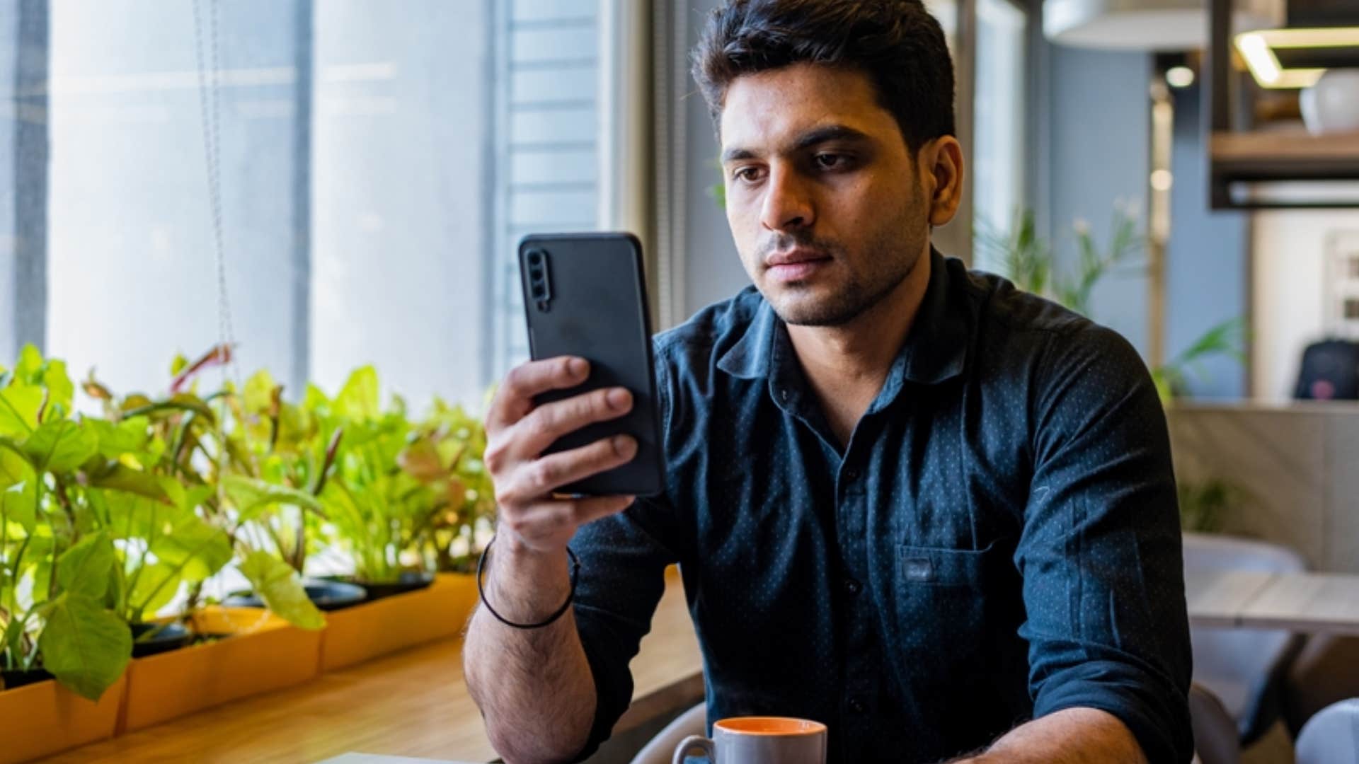 man endlessly scrolling through phone