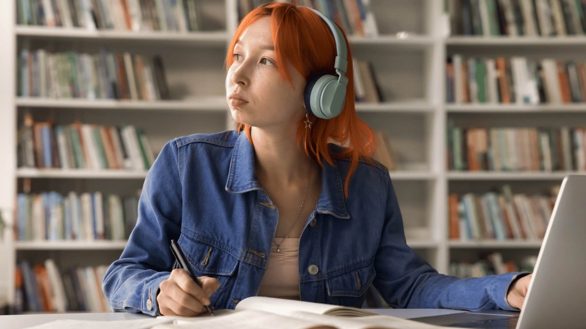 young woman working hard in the library worried about being productive