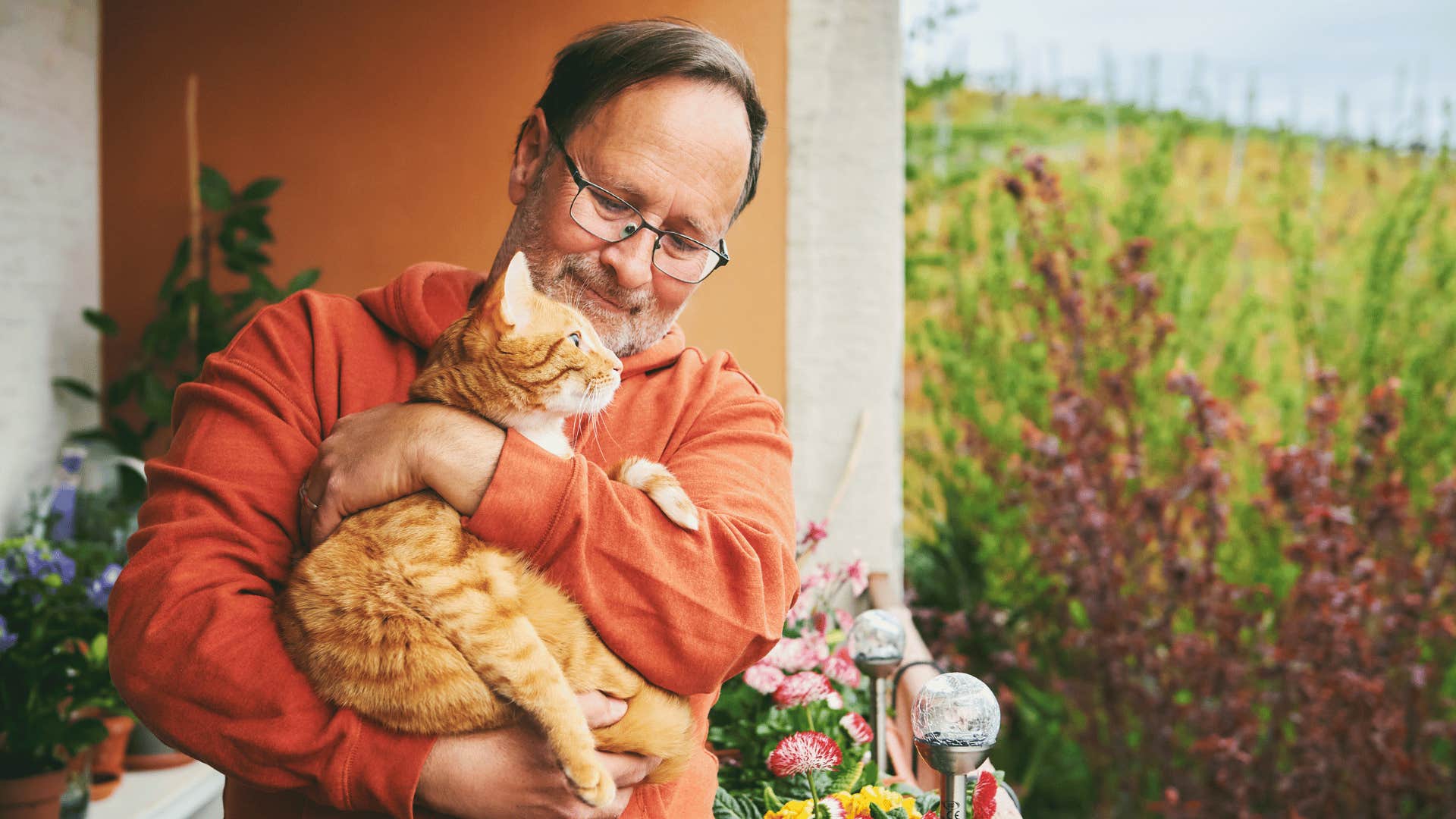 Man whose parents raised him well holds pet cat
