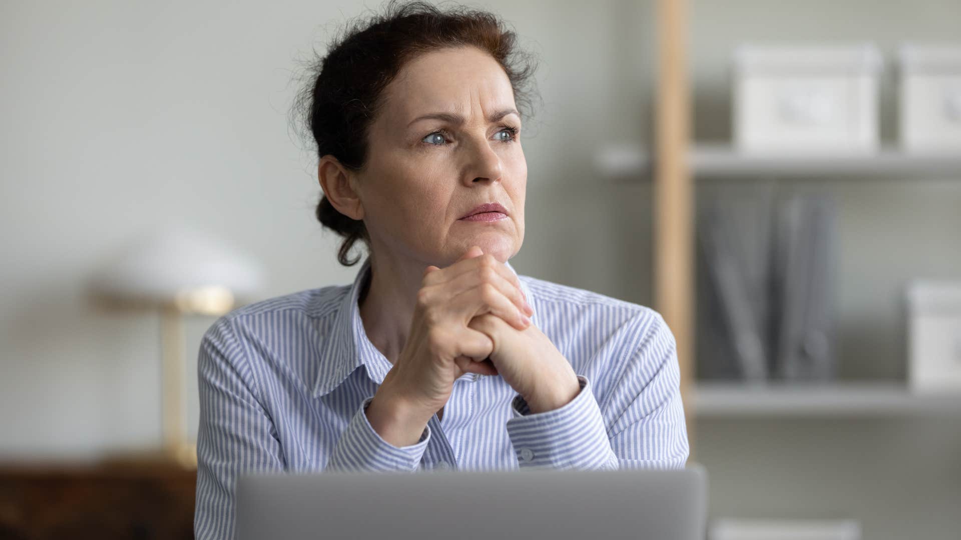 boomer woman thinking about enforcing a rigid dress code at work