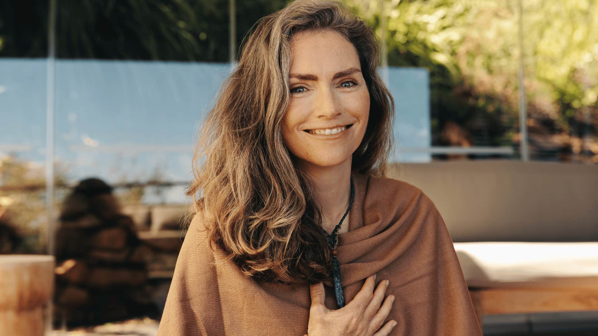 Happy woman smiling, no longer considered mentally ill for liking witchy things
