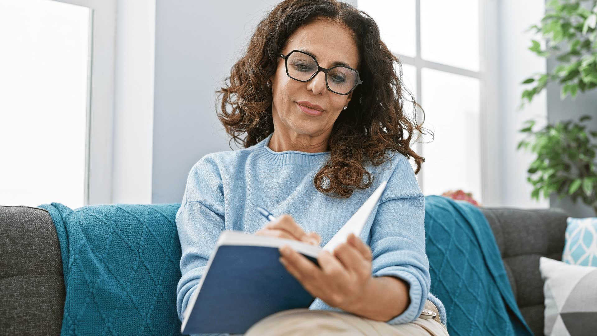 Woman writing in a journal no longer considered mentally ill for her love of writing 