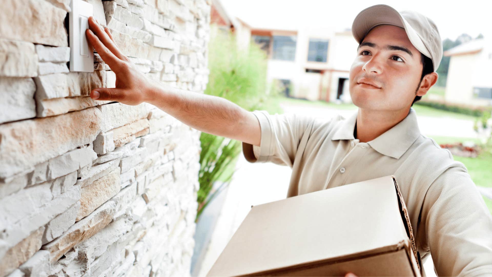 A delivery driver rings the doorbell at a home.
