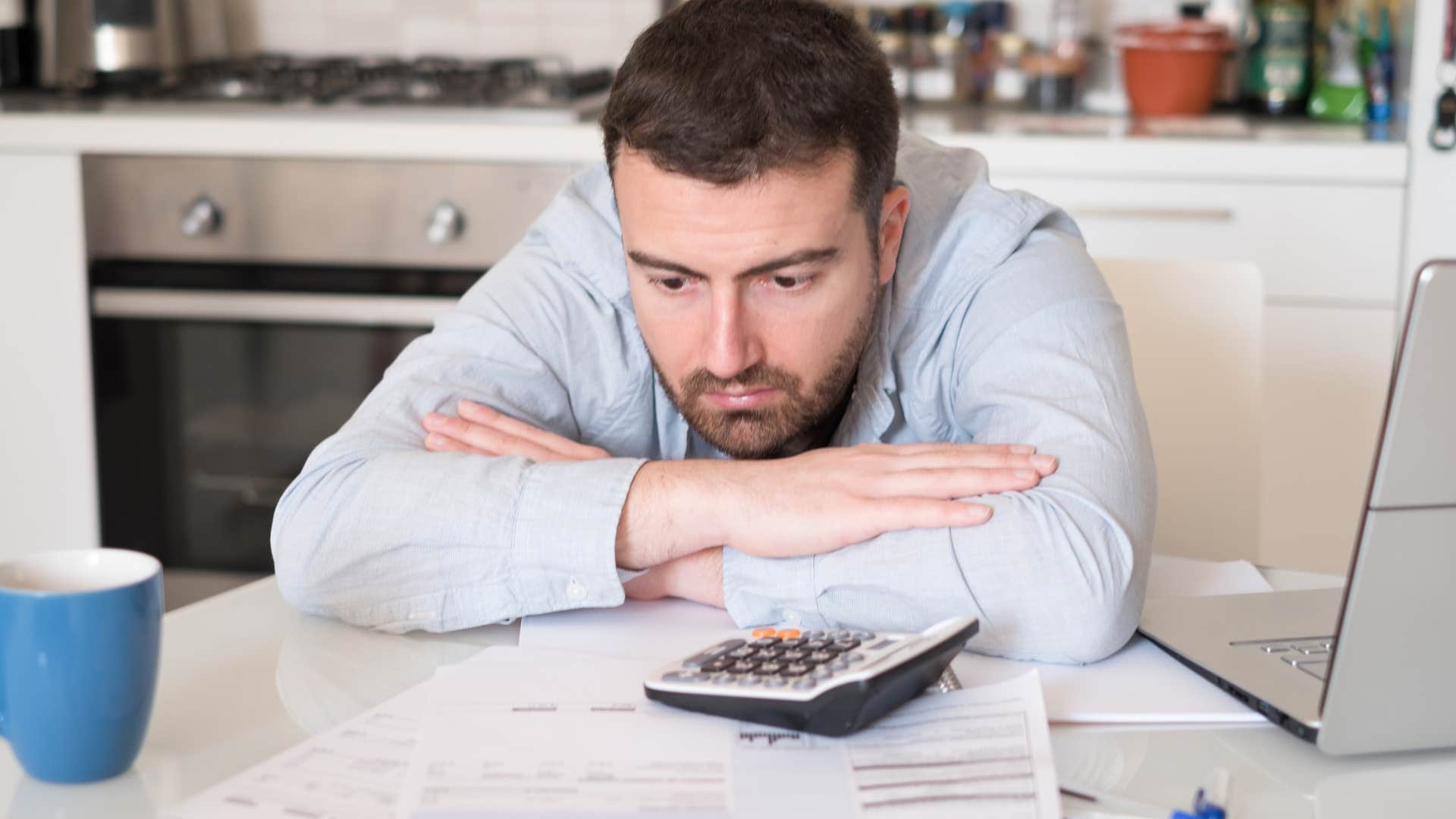 Man managing their own financing looking stressed.