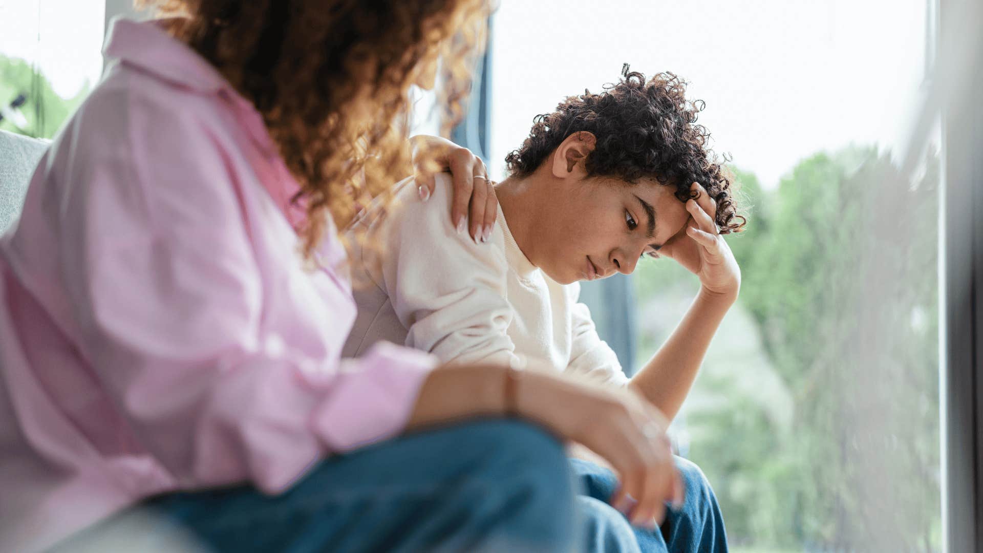 well-meaning mother talking to upset son