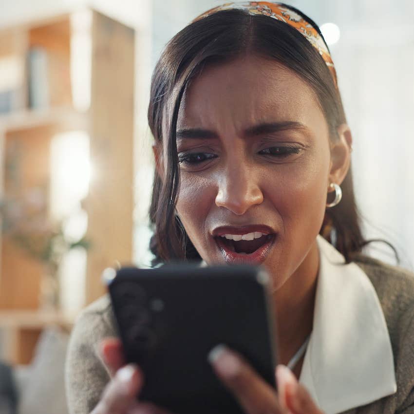 upset woman looking at his phone that totally backfires