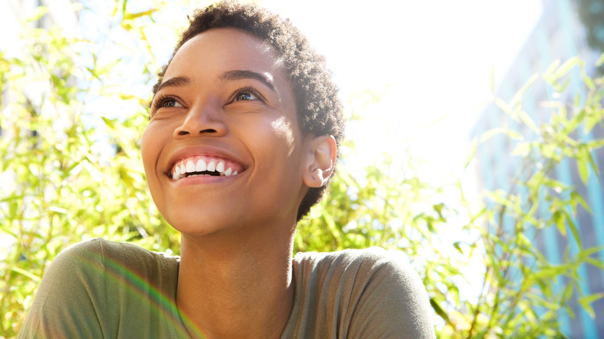 Woman who enjoys their alone time smiling outside.