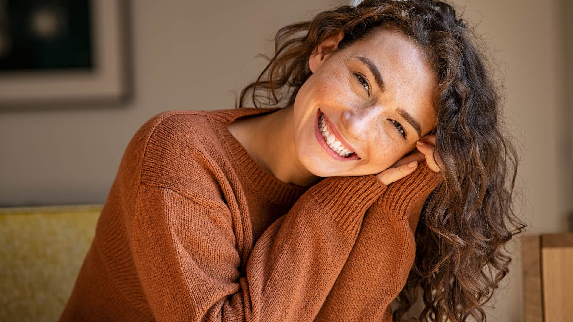 Happy woman who doesn't chase people smiling at the camera.