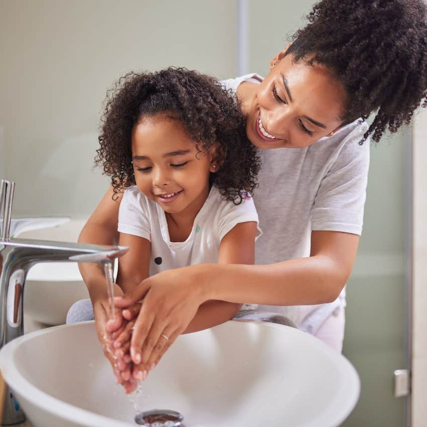 woman who thinks shes a bad parent washing child's hands