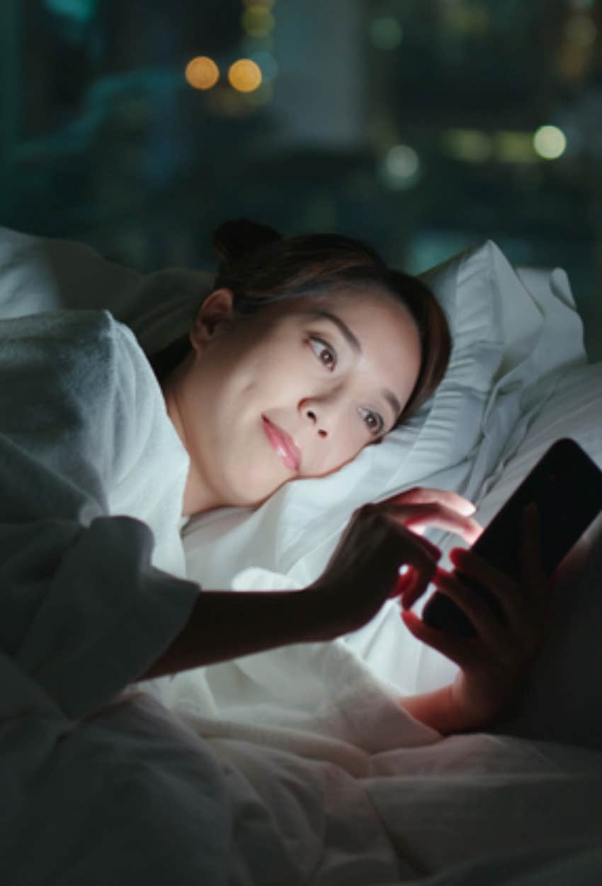 woman checking phone in morning