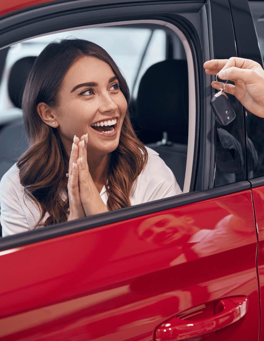 A woman accepts the keyless car starter for her brand new car.