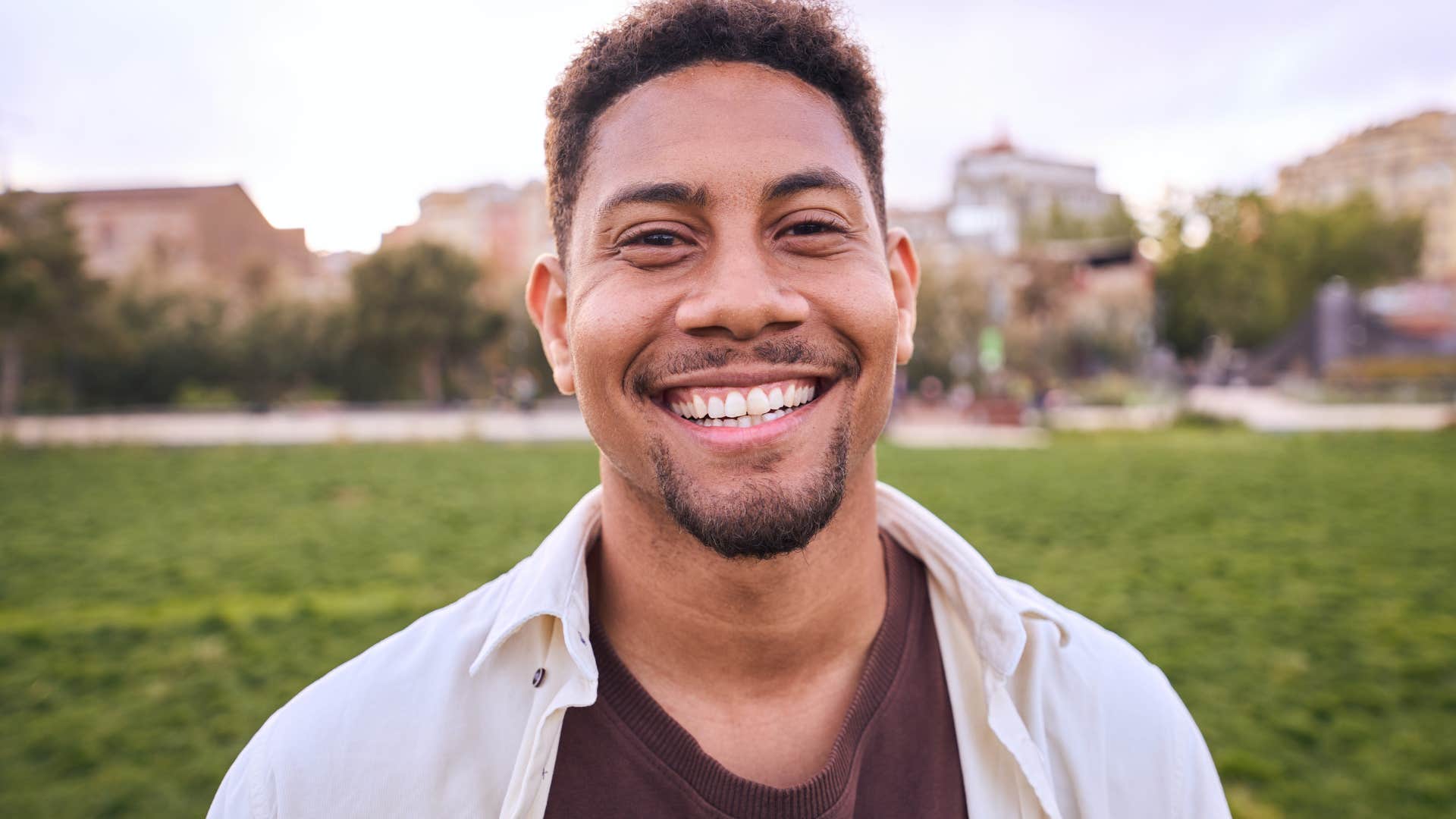Man who knows nobody has it all figured out smiling at the camera.