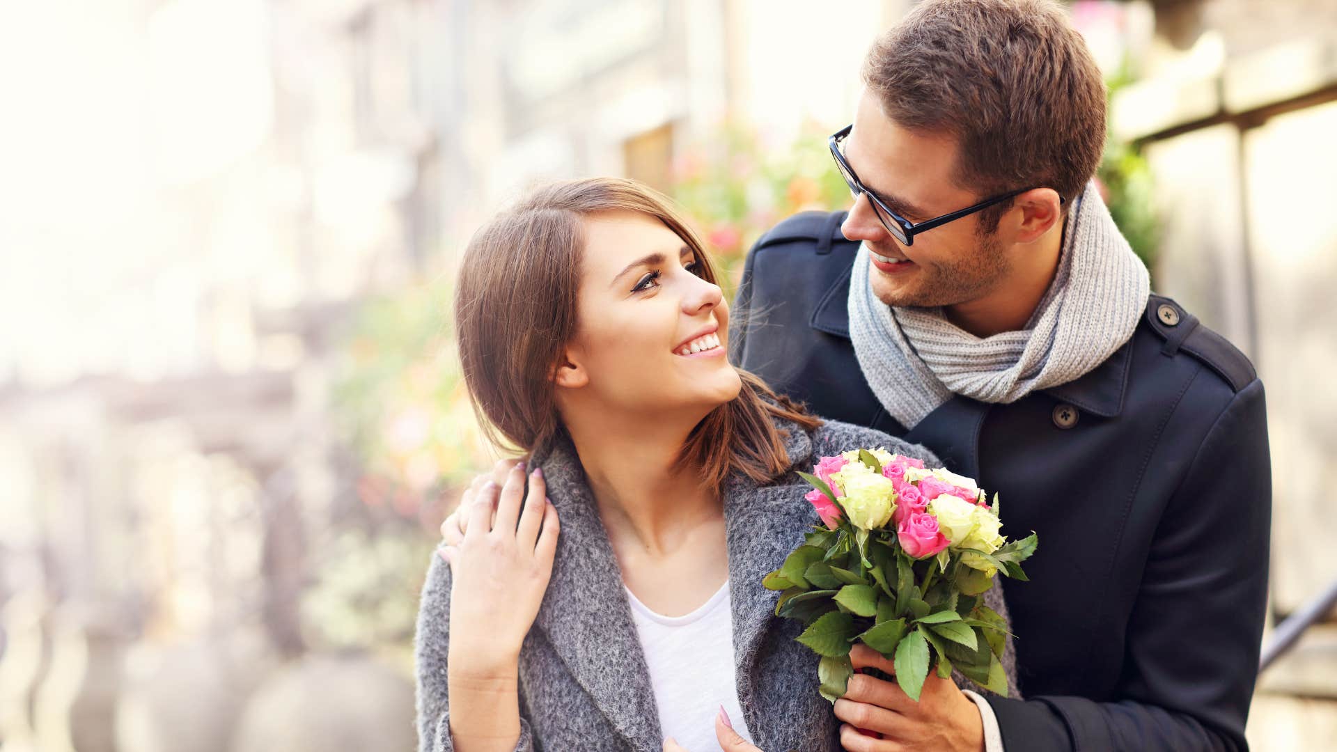 man giving woman flowers as romantic gesture