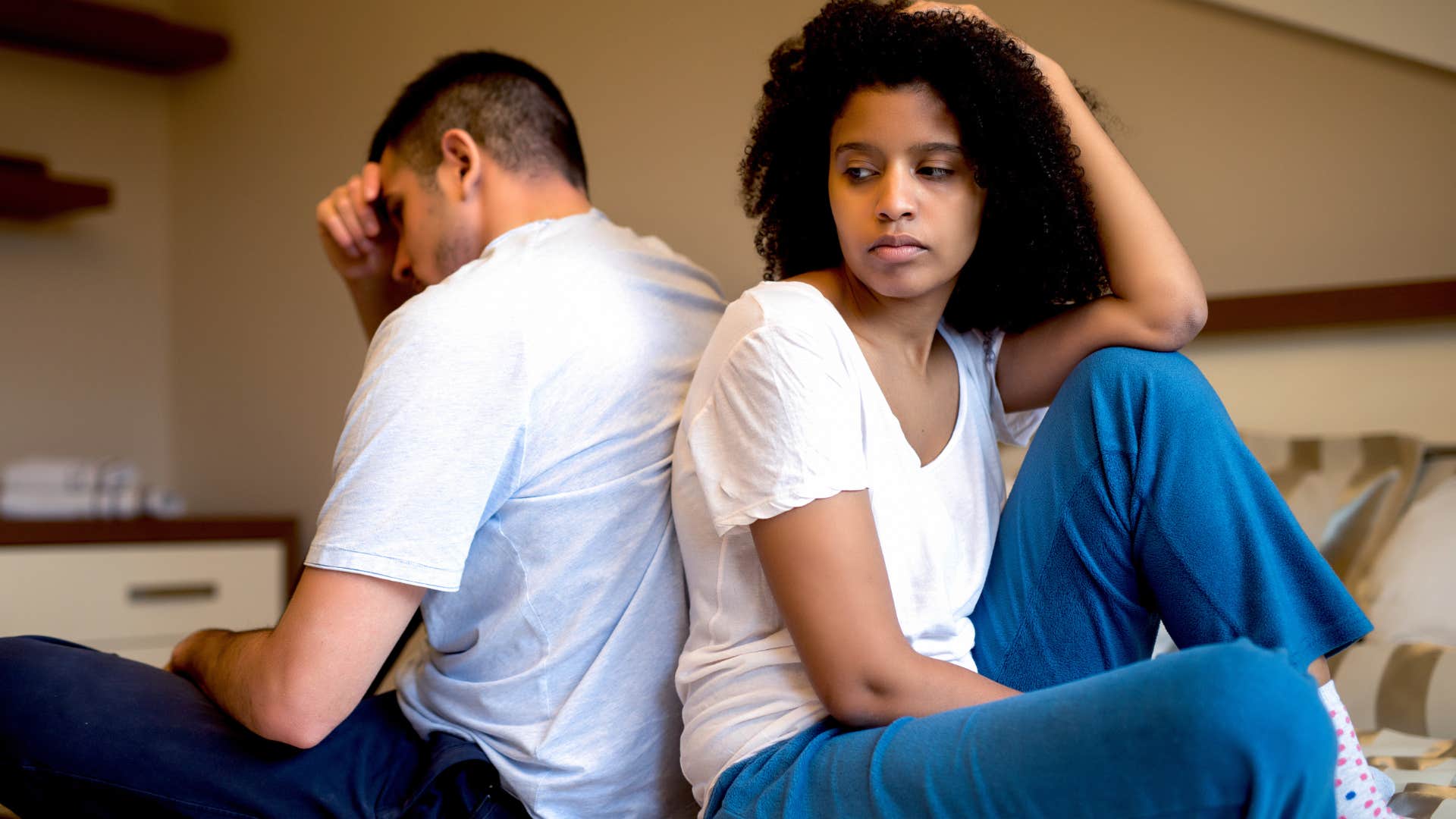 woman feeling like her relationship is stagnant turned away from partner