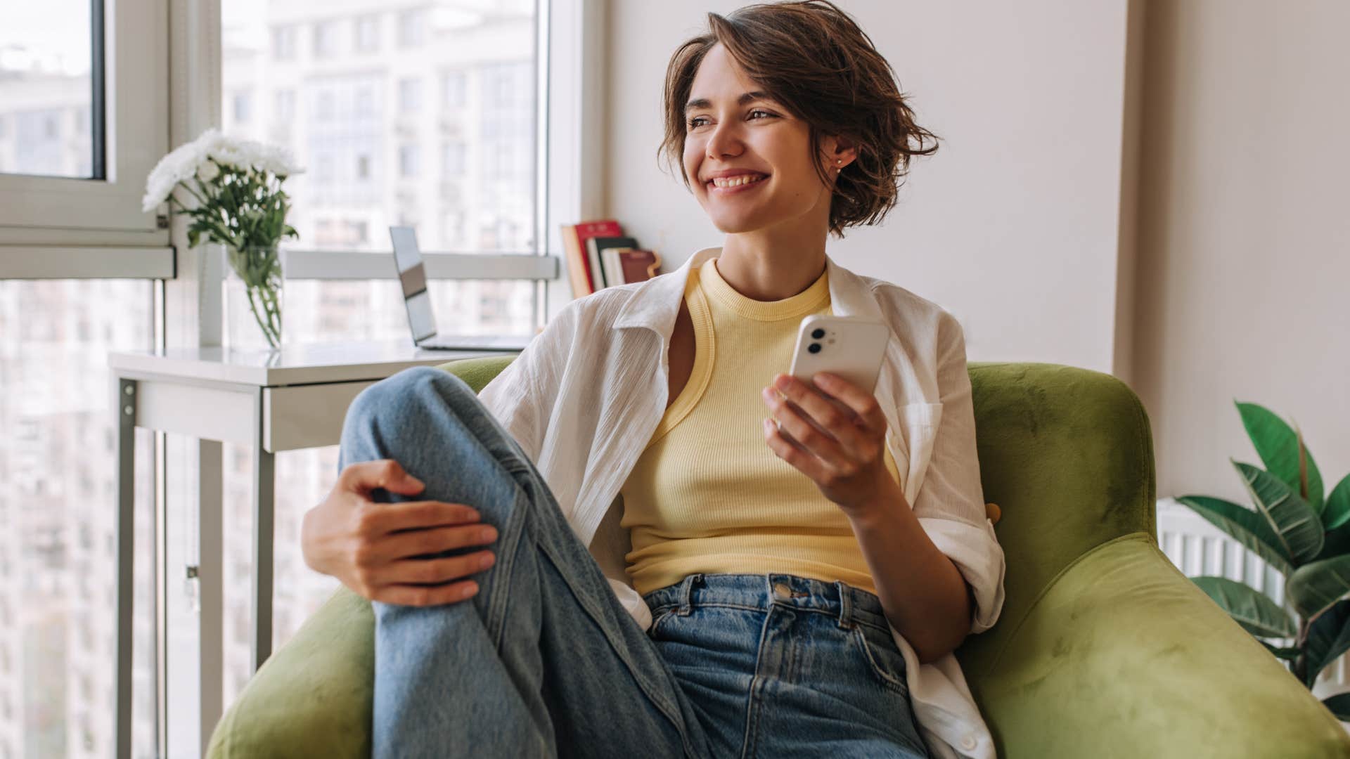 woman sitting in furniture facing away from her door