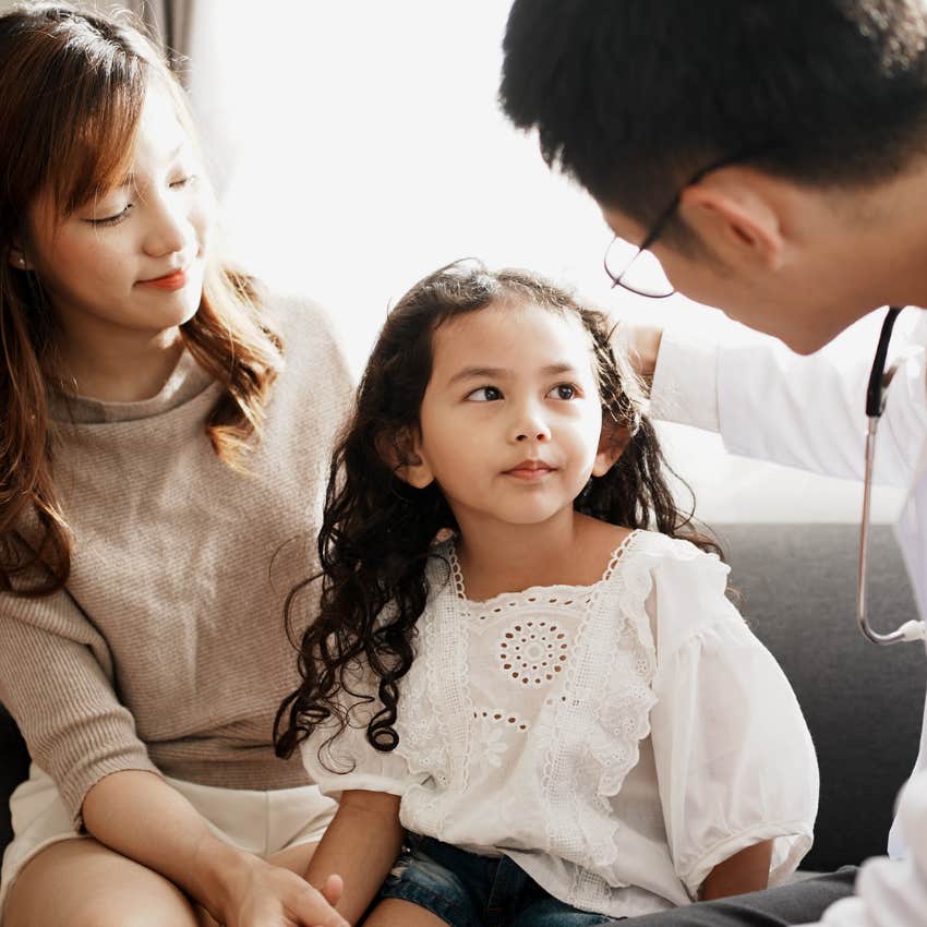 child with doctor and emotionally absent mother