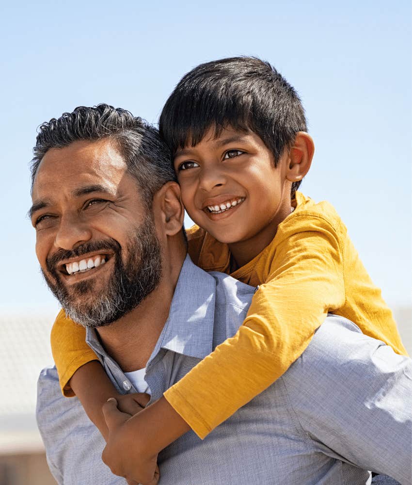 Child on father's back is shaped by parent to learn trust