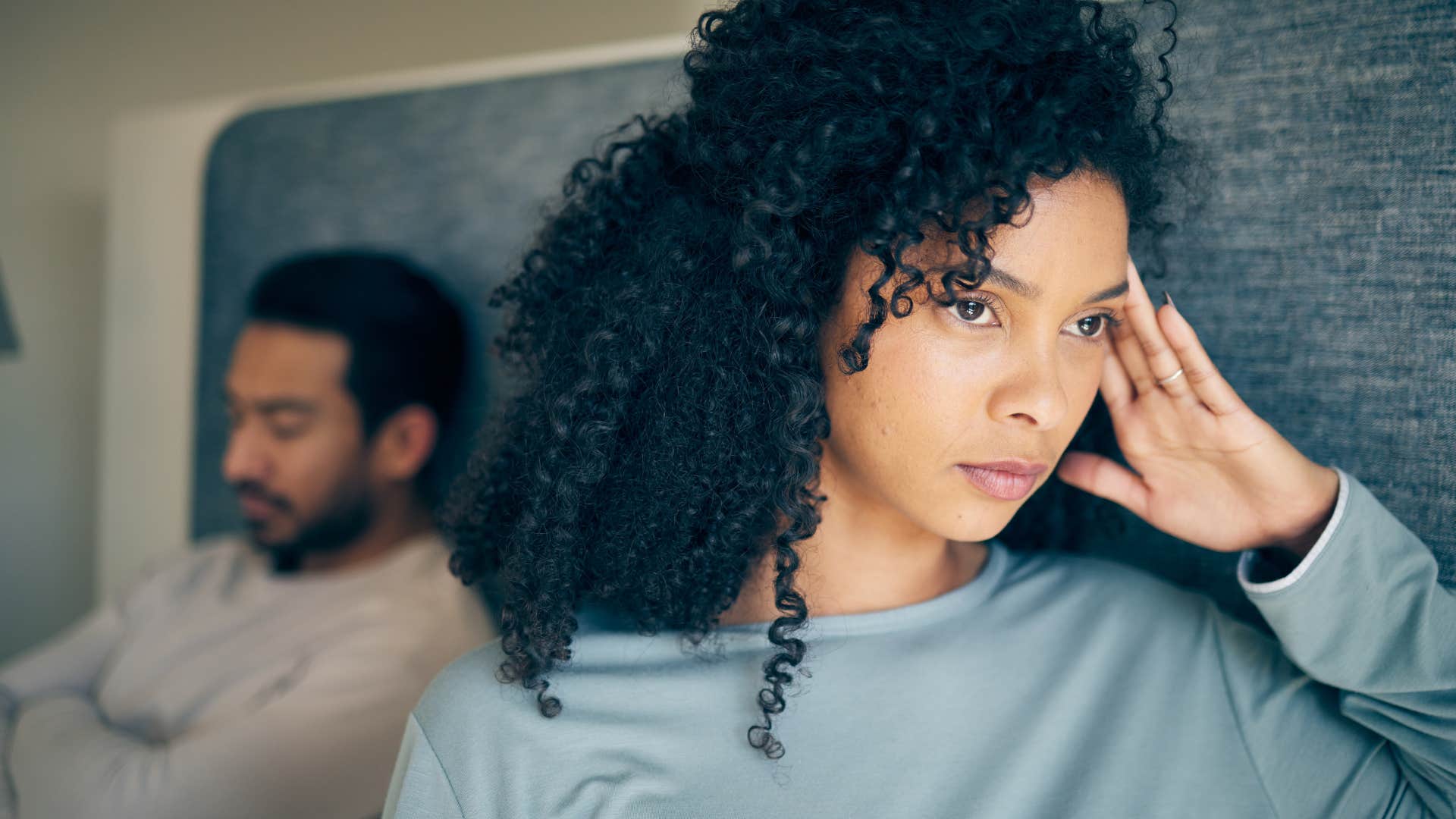 upset woman not setting boundaries turned away from man