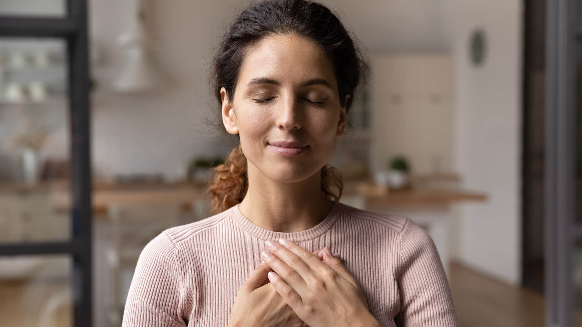 woman practicing a self-soothing techniques meditating