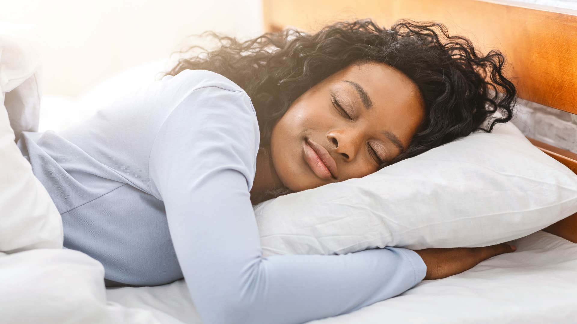 woman prioritizing quality sleep snoozing in bed